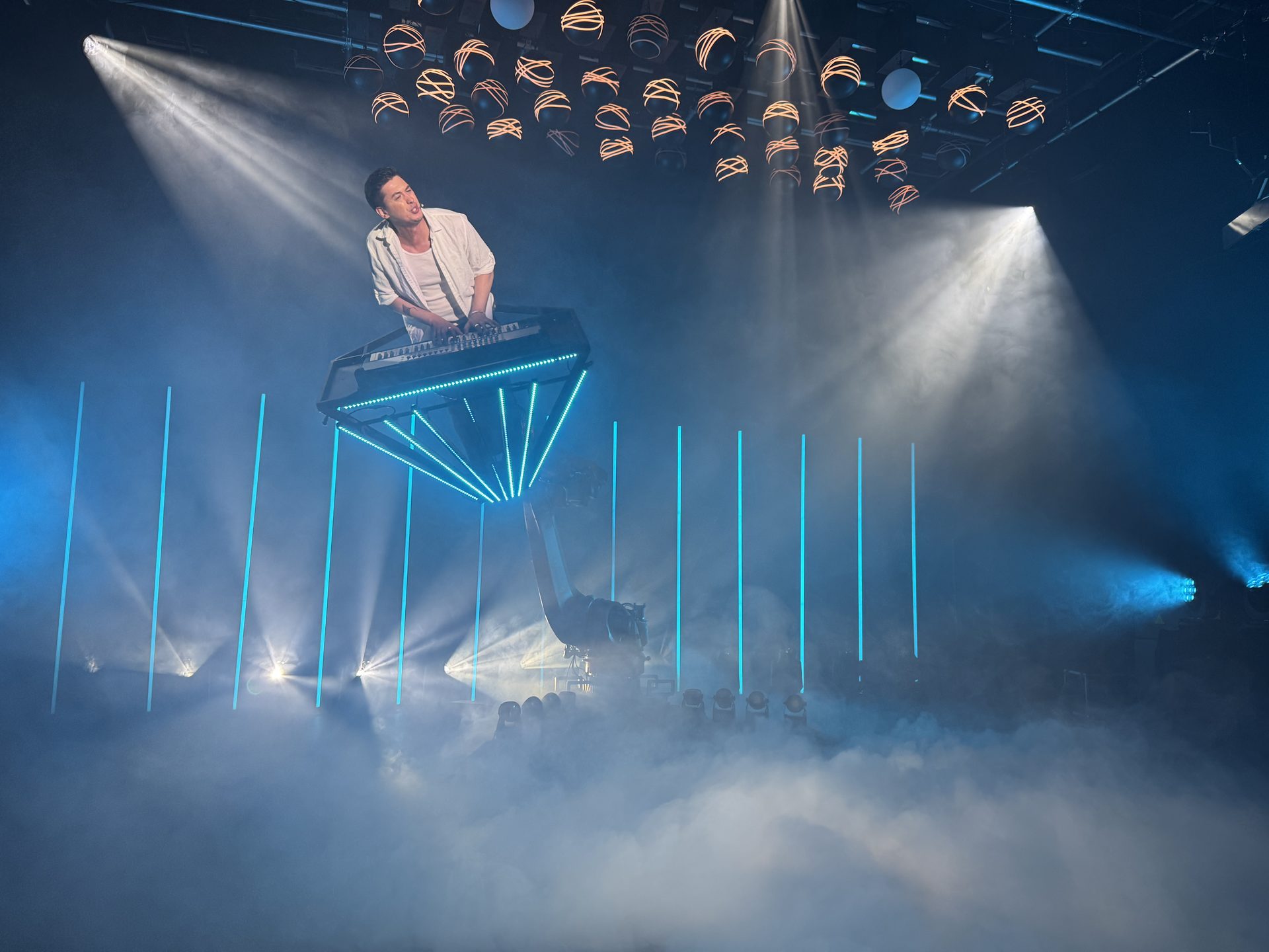 DJ booth with blue lasers and smoke